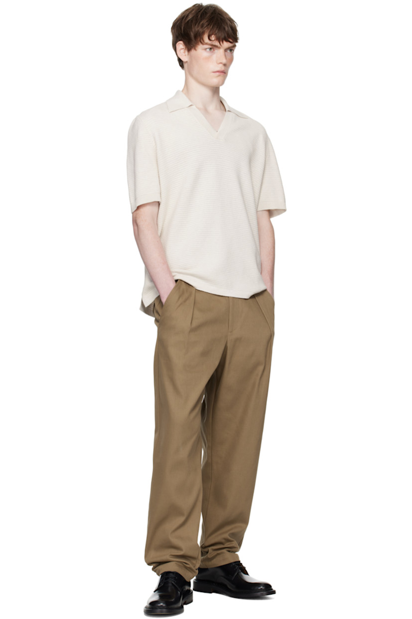 Textured knit cotton polo.

· Rib-knit spread collar and cuffs
· Open placket
· Vented side seams

Supplier color: Heathered ecru