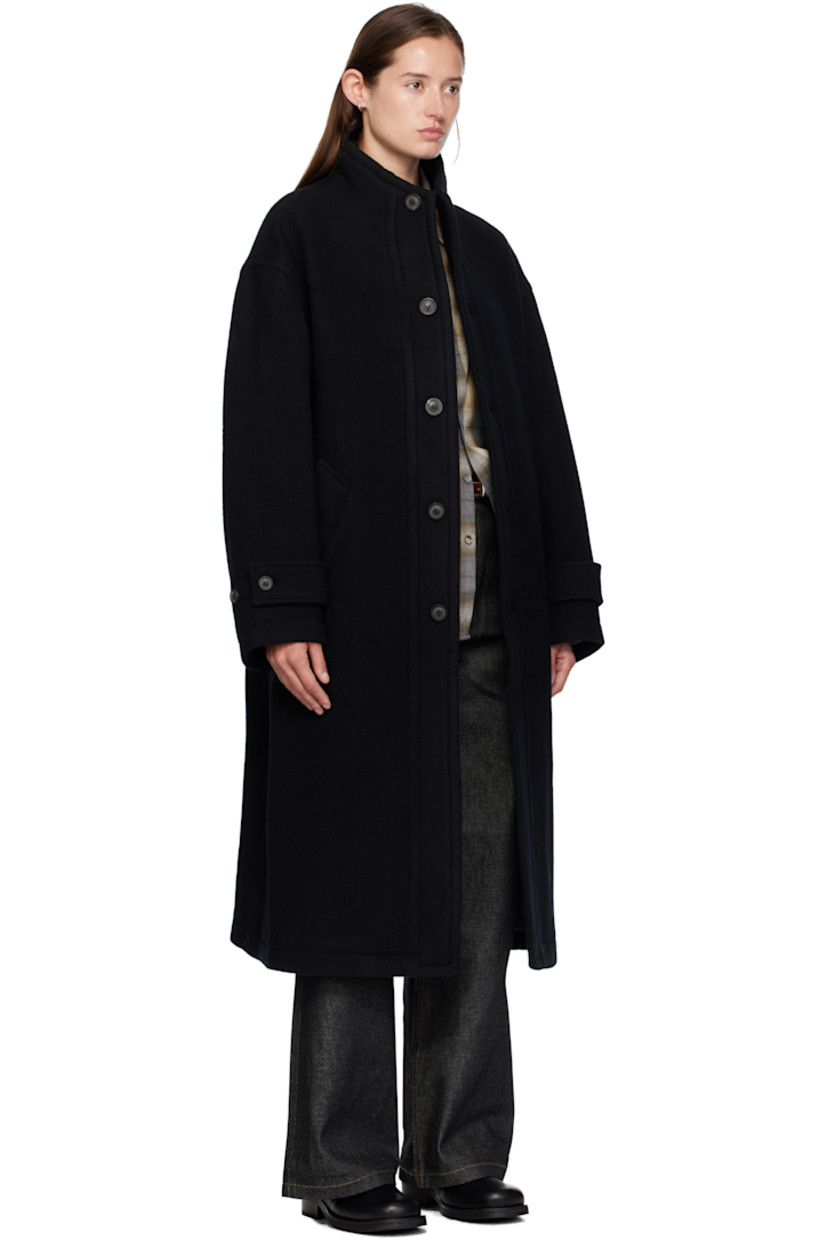 Wool-blend melton coat. 

· Stand collar 
· Button closure
· Welt pockets at waist
· Dropped shoulders
· Button tab at cuffs
· Central vent at back hem 
· Welt pocket at interior 
· Full satin lining 

Supplier color: Black