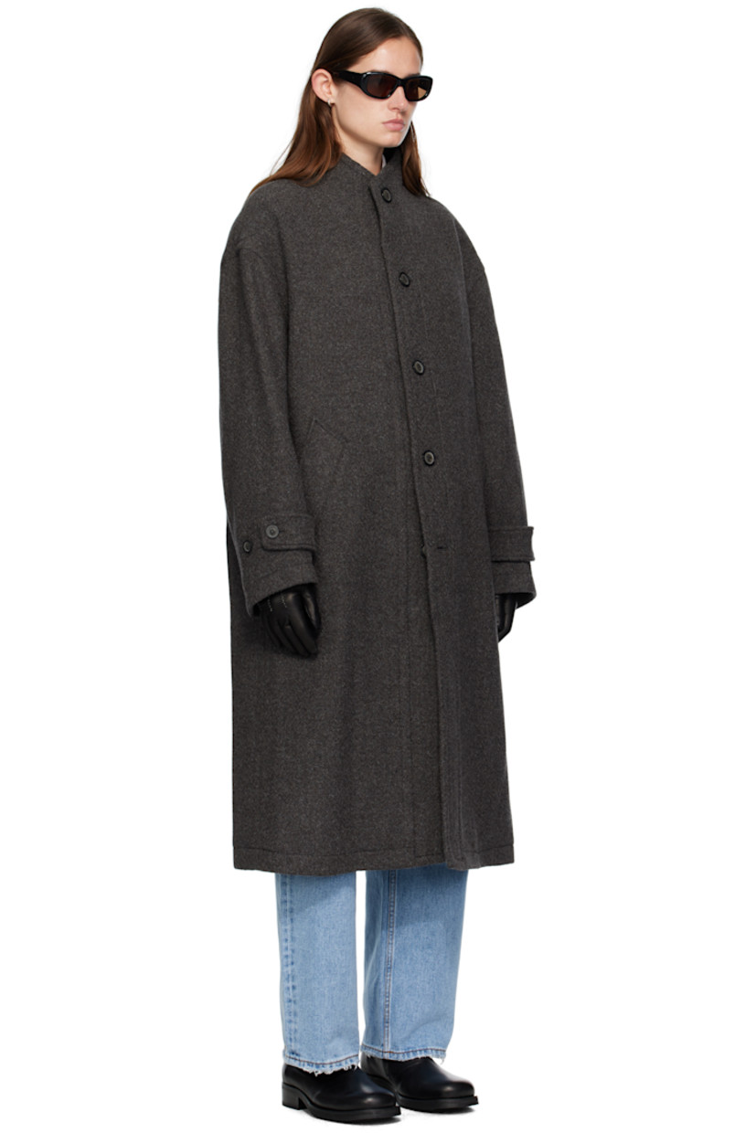 Wool- and cashmere-blend melton coat. 

· Stand collar 
· Button closure
· Welt pockets at waist
· Dropped shoulders
· Button tab at cuffs
· Central vent at back hem 
· Welt pocket at interior 
· Full satin lining 

Supplier color: Cinder grey