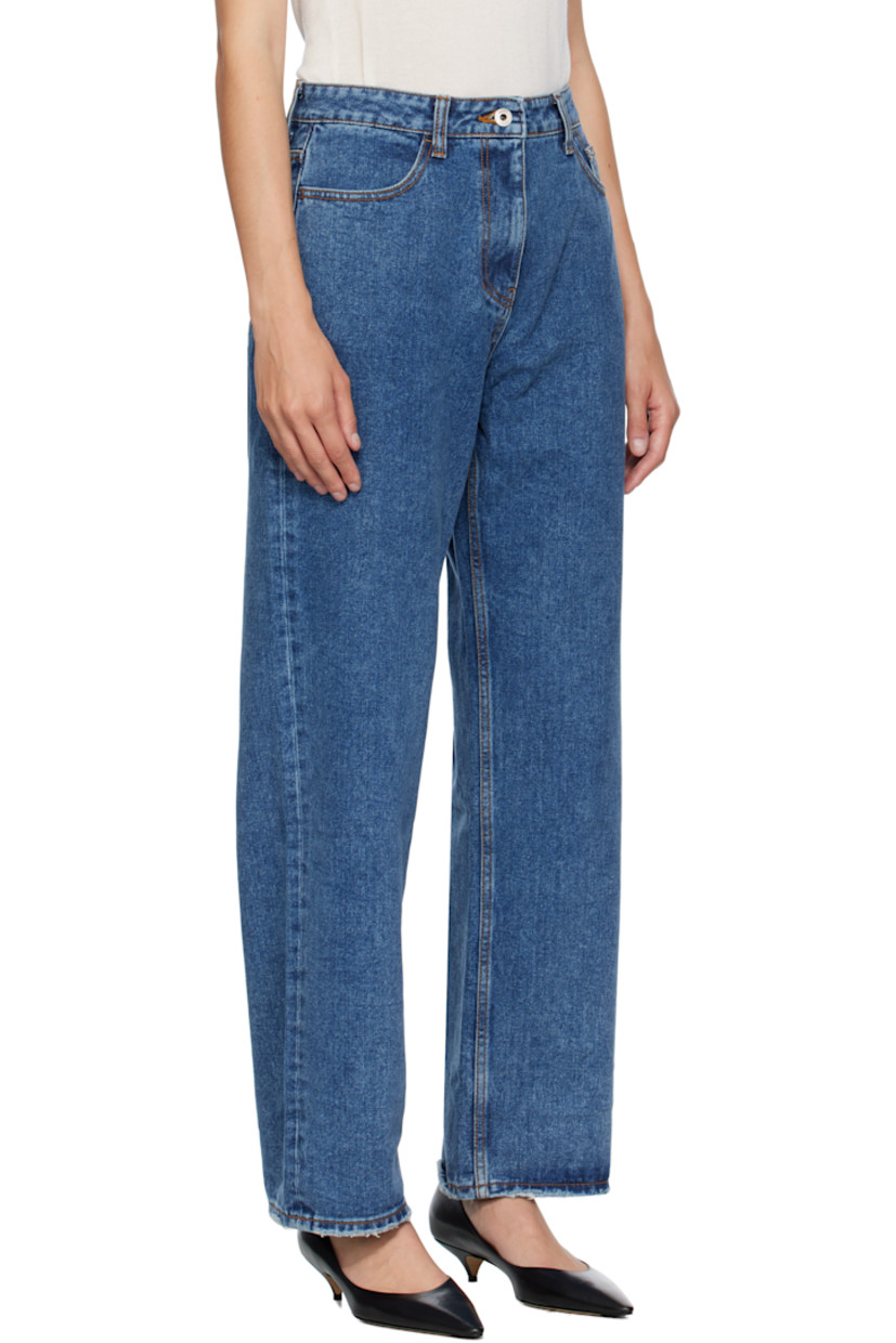 Non-stretch denim jeans. 

· Loose-fit 
· Fading and subtle distressing throughout 
· Belt loops
· Five-pocket styling
· Zip fly 
· Logo patch at back waistband
· Raw edge at cuffs
· Contrast stitching in tan 

Supplier color: Indigo
