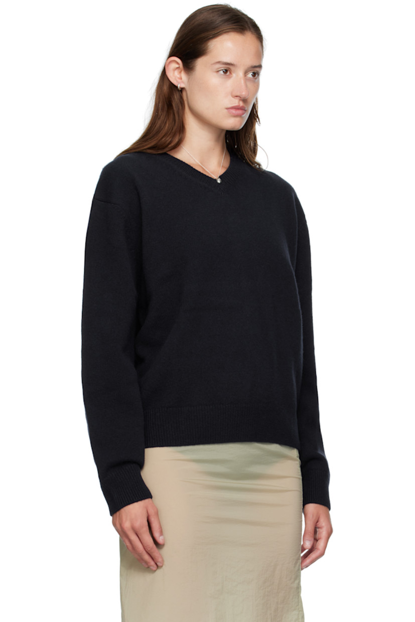Knit wool sweater. 

· Rib-knit V-neck, hem, and cuffs
· Dropped shoulders

Supplier color: Navy