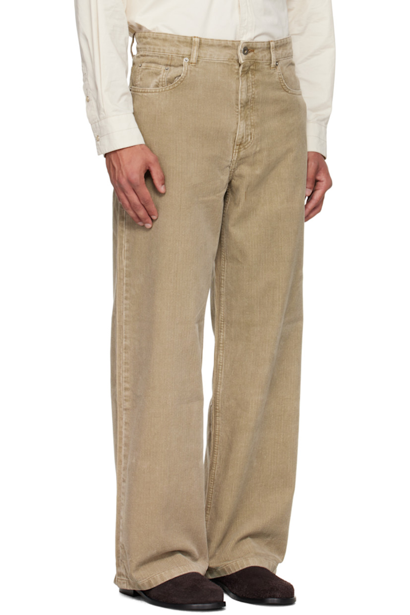 Cotton corduroy trousers.

· Wide-leg
· Belt loops
· Five-pocket styling
· Zip fly
· Logo patch at back waistband
· Contrast stitching in tan

Supplier color: Washed beige