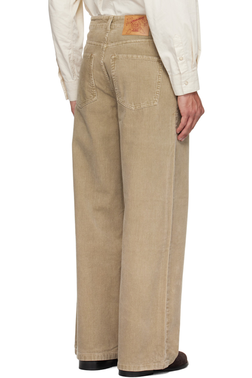 Cotton corduroy trousers.

· Wide-leg
· Belt loops
· Five-pocket styling
· Zip fly
· Logo patch at back waistband
· Contrast stitching in tan

Supplier color: Washed beige