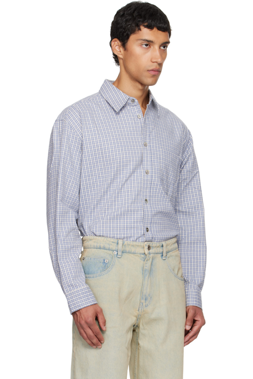 Cotton flannel shirt.

· Check pattern throughout
· Spread collar
· Button closure
· Patch pocket at chest
· Shirttail hem
· Buttoned barrel cuffs
· Locker loop and box pleat at back yoke

Supplier color: Blue check