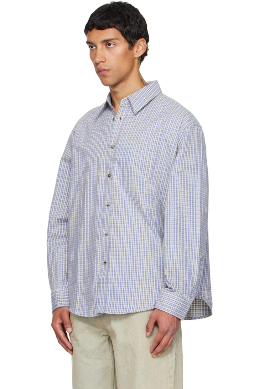 Cotton flannel shirt.

· Check pattern throughout
· Spread collar
· Button closure
· Patch pocket at chest
· Shirttail hem
· Buttoned barrel cuffs
· Locker loop and box pleat at back yoke

Supplier color: Blue check