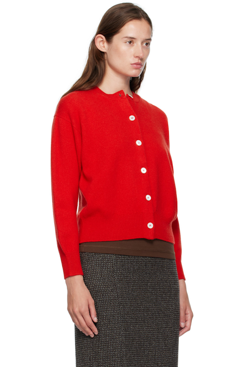 Handcrafted knit Geelong lambswool cardigan. 

· Rib-knit crewneck, hem, and cuffs
· Button closure
· Dropped shoulders

Supplier color: Poppy red