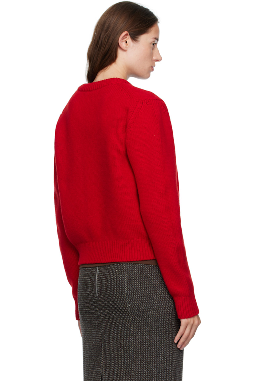 Handcrafted knit Geelong lambswool sweater. Rib-knit V-neck, hem, and cuffs.

Supplier color: Ruby red
