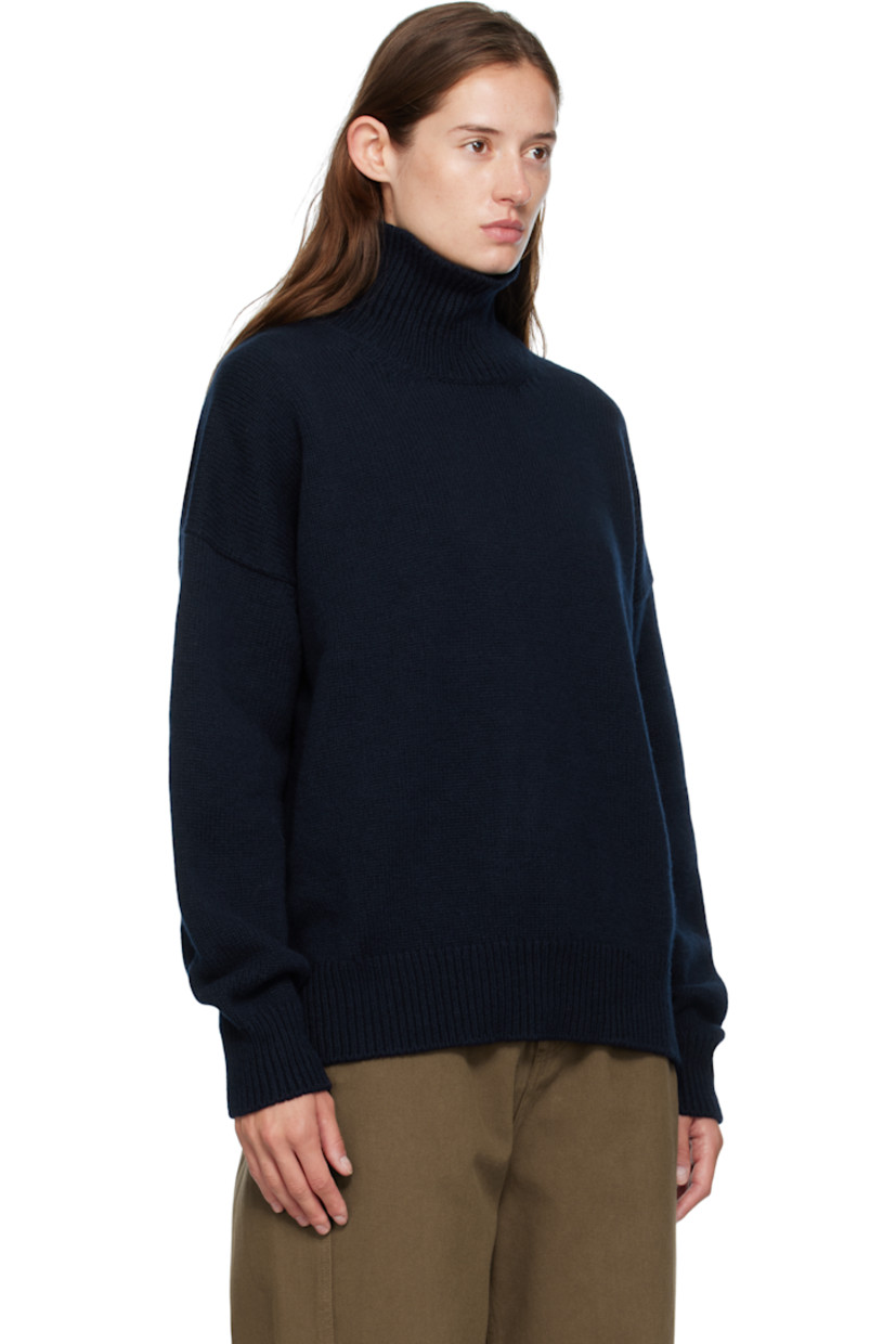 Knit virgin wool turtleneck.

· RWS-certified virgin wool
· Fully fashioned construction
· Rib-knit collar, hem, and cuffs
· Dropped shoulders

Supplier color: Navy