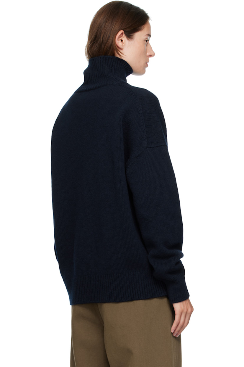 Knit virgin wool turtleneck.

· RWS-certified virgin wool
· Fully fashioned construction
· Rib-knit collar, hem, and cuffs
· Dropped shoulders

Supplier color: Navy