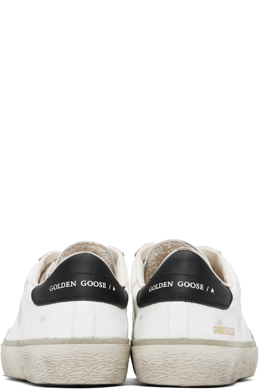Handcrafted low-top buffed leather sneakers in white. 

· Smudging throughout
· Lace-up closure
· Logo stamp and star embossed at padded tongue
· Padded collar 
· Logo stamp at vamp 
· Logo stamp at outer side and heel tab 
· Terrycloth lining 
· Treaded rubber sole 

Supplier color: White/Black