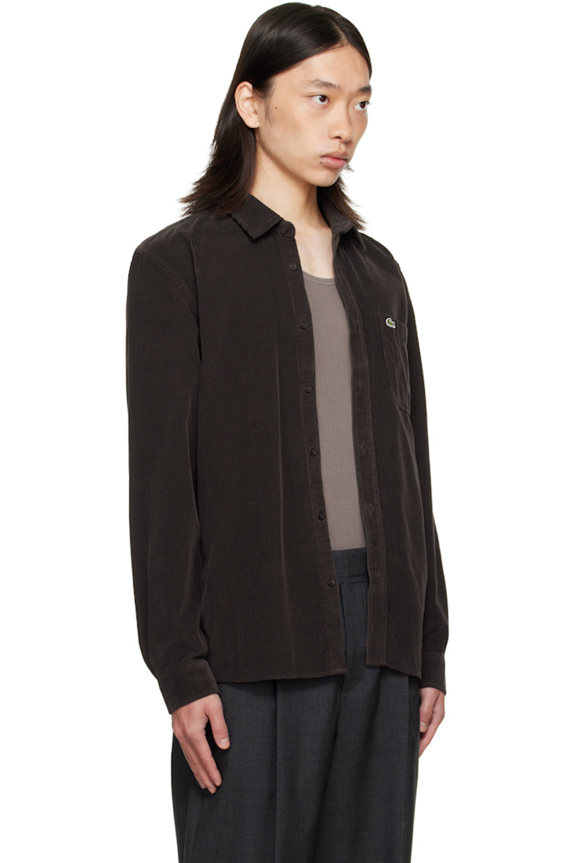 Cotton corduroy shirt.

· Spread collar
· Button closure
· Logo patch and patch pocket at chest
· Shirttail hem
· Buttoned barrel cuffs
· Pleats at back yoke

Supplier color: Port