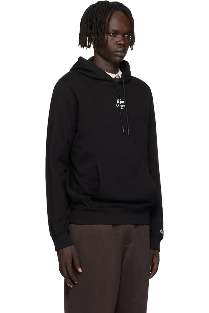 Cotton French terry hoodie.

· Drawstring at hood
· Logo printed at chest and back
· Kangaroo pocket at waist 
· Rib-knit hem and cuffs
· Embroidered logo patch at cuff

Supplier color: Black