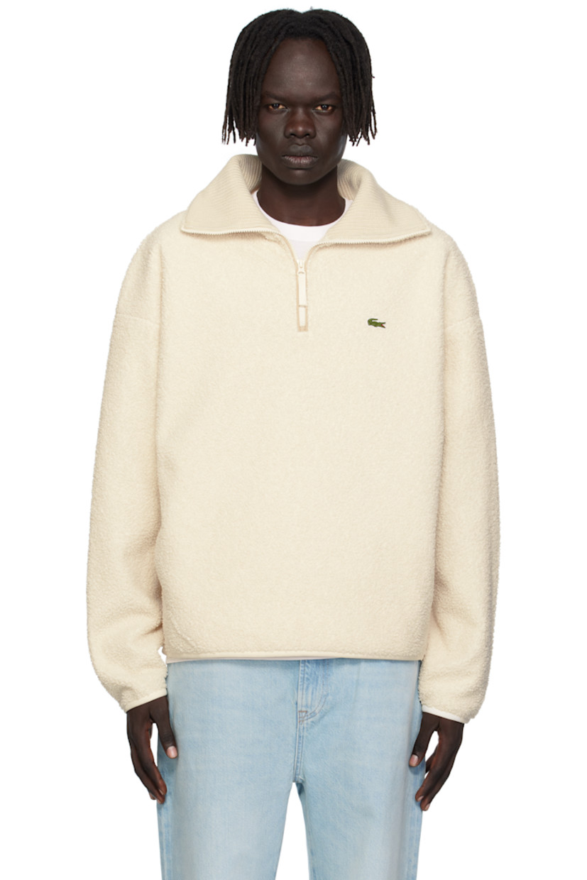 Sherpa fleece sweatshirt. 

· Rib-knit interior at stand collar 
· Half-zip closure 
· Embroidered logo patch at chest
· Seam pockets at waist
· Dropped shoulders

Supplier color: Lapland