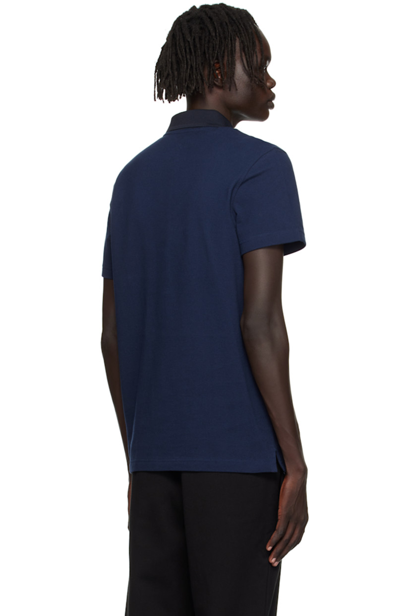 Lightweight organic cotton piqué polo.

· Knit spread collar and placket
· Concealed three-button placket
· Embroidered logo patch at chest
· Vented side seams
· Logo-engraved hardware

Supplier color: Navy blue/Abysm