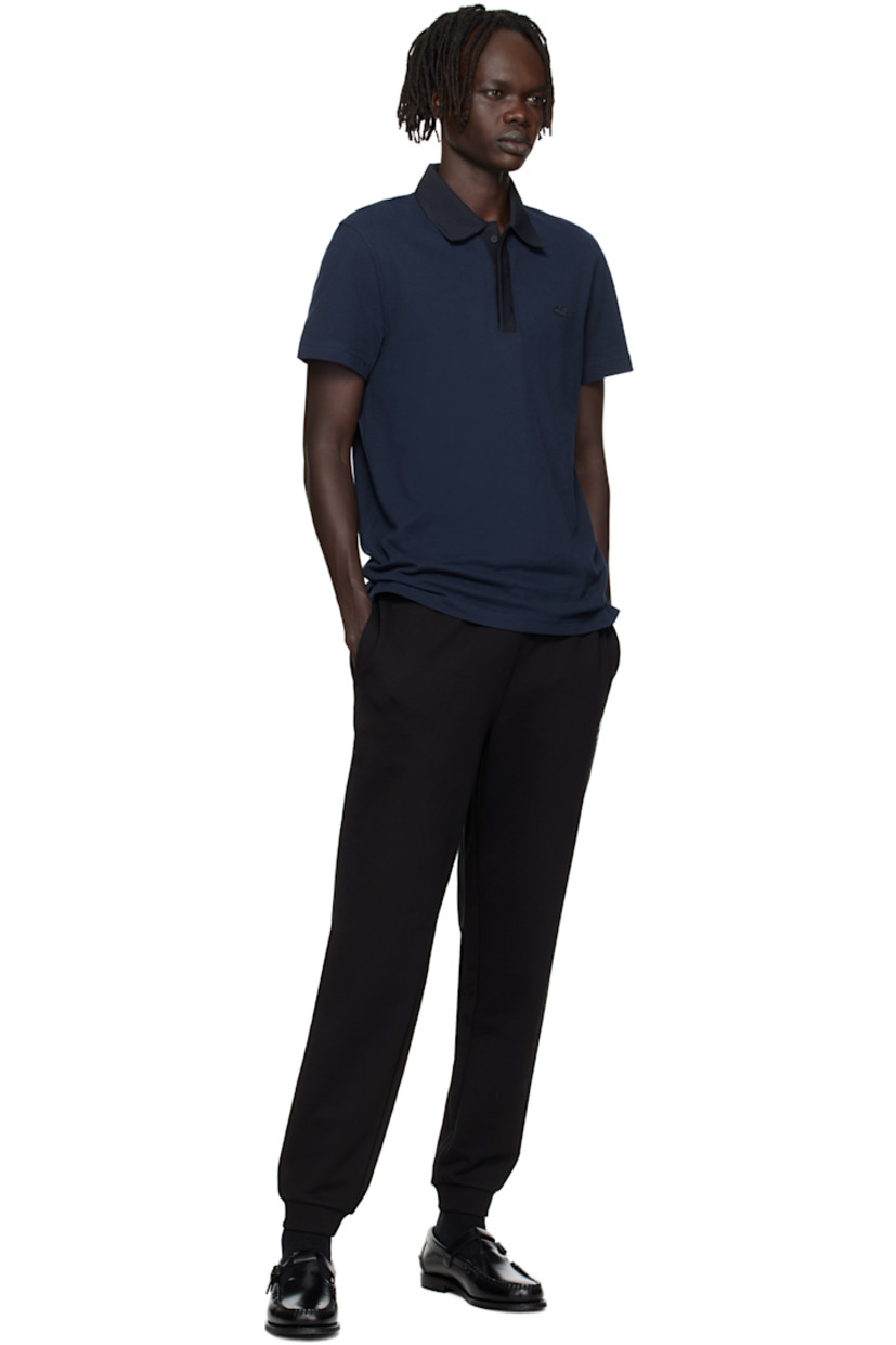 Lightweight organic cotton piqué polo.

· Knit spread collar and placket
· Concealed three-button placket
· Embroidered logo patch at chest
· Vented side seams
· Logo-engraved hardware

Supplier color: Navy blue/Abysm