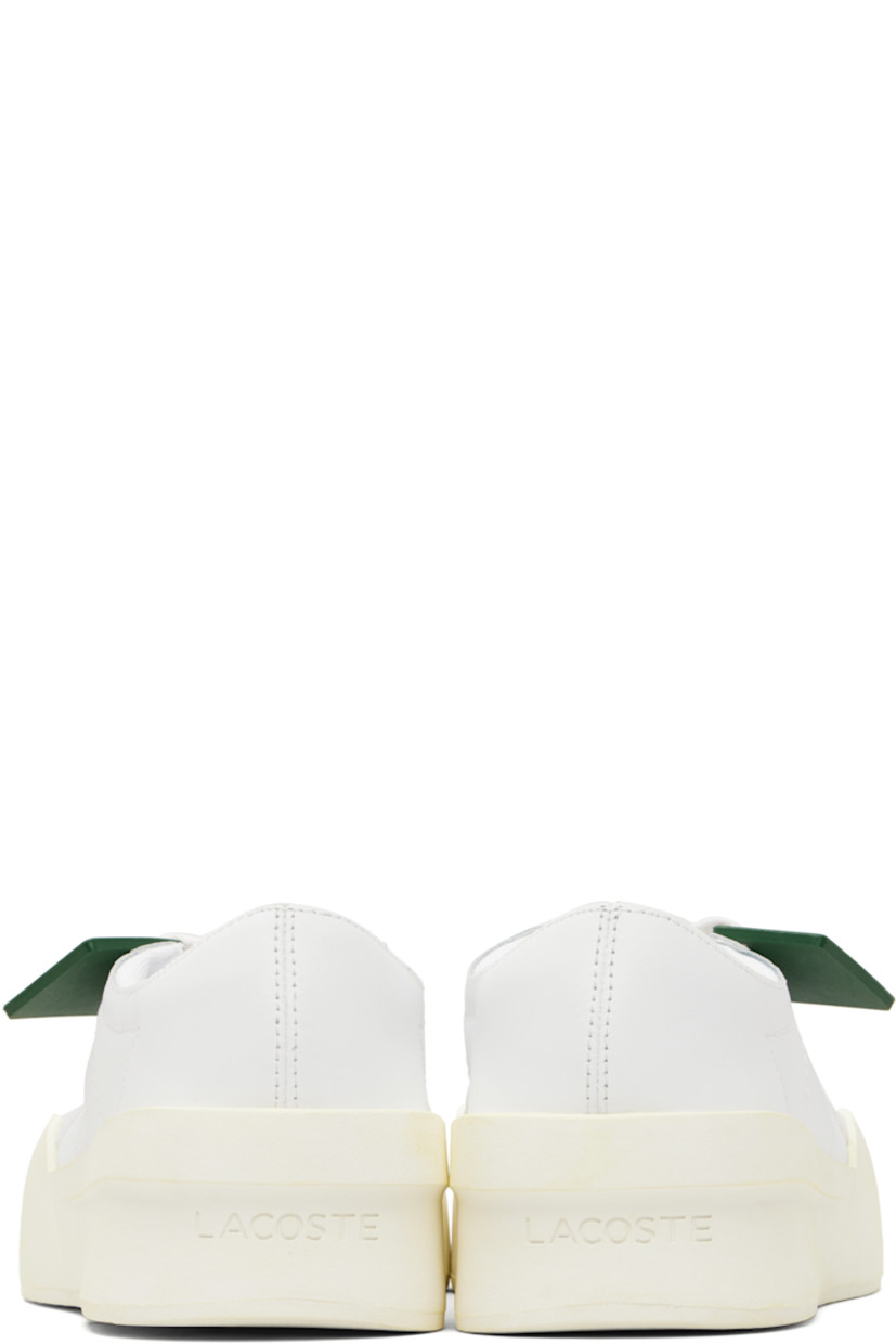 Low-top buffed leather sneakers.

· Perforations at toe and outer side
· Rubber logo tag at lace-up closure
· Woven tongue
· Padded collar
· Logo embossed at heel
· Mesh lining
· Treaded rubber sole
· Heel: H2"

Supplier color: White/Off white