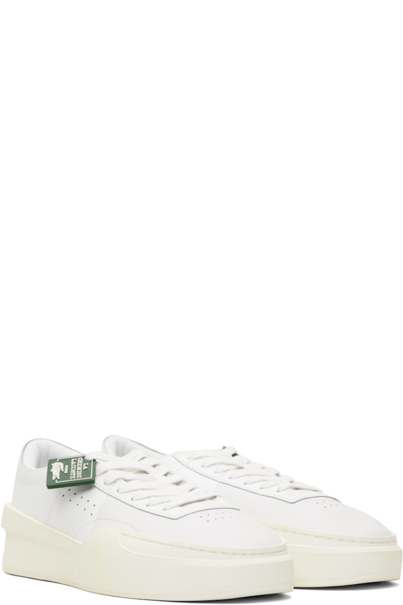 Low-top buffed leather sneakers.

· Perforations at toe and outer side
· Rubber logo tag at lace-up closure
· Woven tongue
· Padded collar
· Logo embossed at heel
· Mesh lining
· Treaded rubber sole
· Heel: H2"

Supplier color: White/Off white