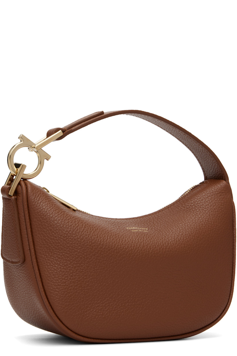 Grained calfskin shoulder bag.

· Logo hardware at fixed shoulder strap
· Logo stamp at face
· Zip closure
· Twill lining
· H5.5" x W8" x D3.5"

Supplier color: Cognac