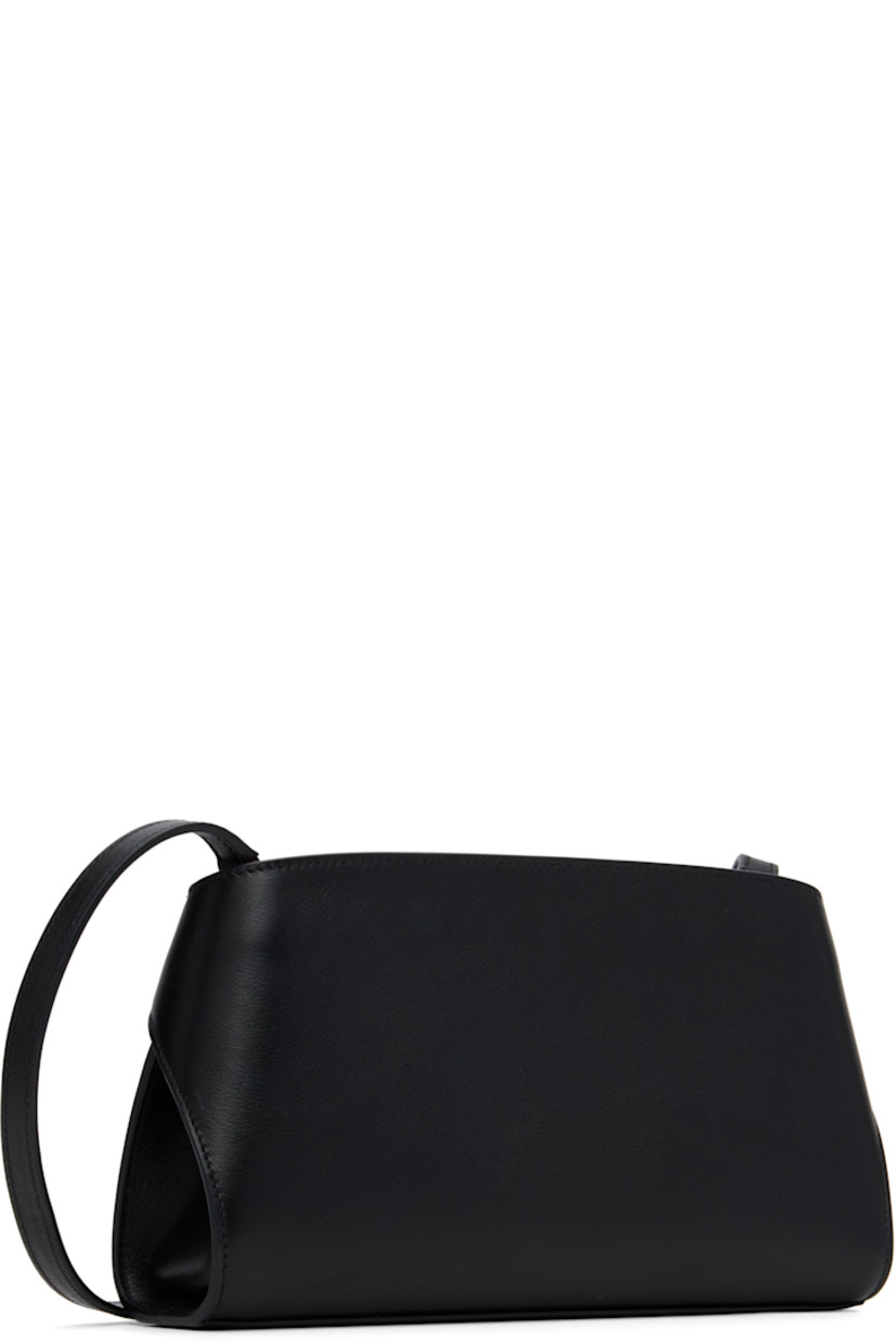 Vegetable-tanned buffed calfskin shoulder bag.

· Adjustable and detachable crossbody strap
· Flip-clasp straps and logo stamp at face
· Zip closure
· Card slots at interior
· Buffed leather lining
· Gold-tone hardware
· H5.5" x W9.25" x D2.5"

Supplier color: Black/Flame Red