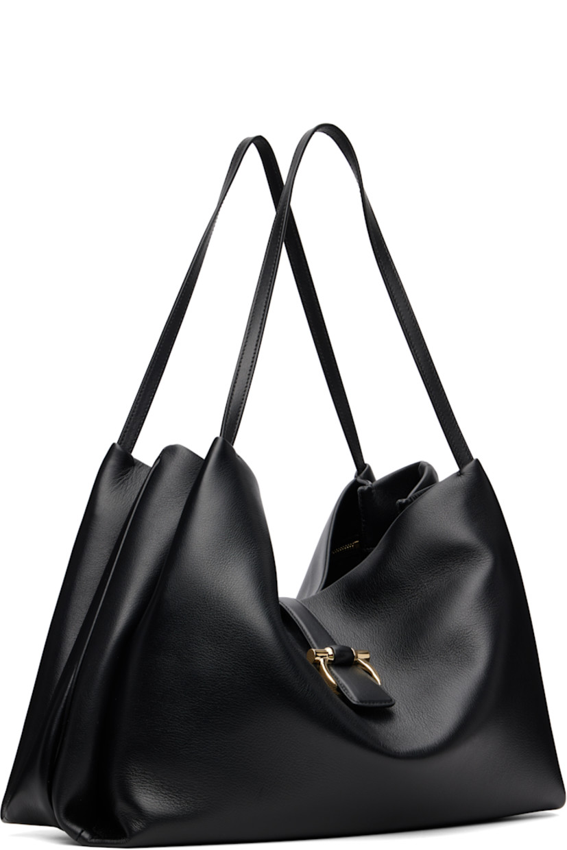 Grained calfskin tote.

· Twin fixed shoulder straps
· Accordion panel at sides
· Logo hardware at magnetic fastening 
· Zip pocket at interior 
· Twill lining
· H11" x W14.5" x D6"

Supplier color: Black
