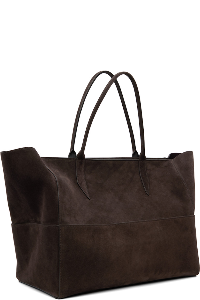 Paneled suede tote.

· Magnetic patch pockets throughout
· Rolled shoulder straps
· Zip closure
· Zip pocket at interior
· Laptop compartment
· Contrast stitching in white
· H13" x W21" x D9.5"

Supplier color: Chocolate
