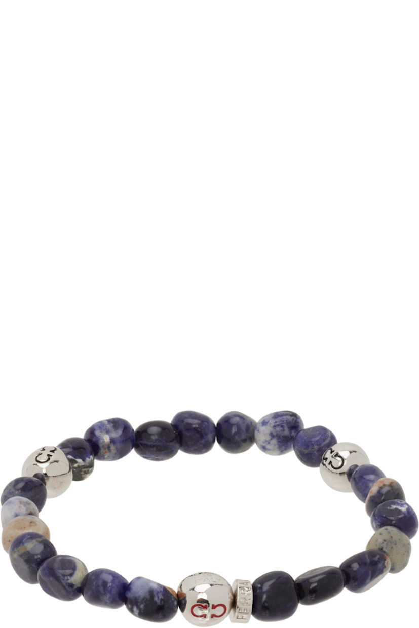 Elasticized beaded stone bracelet in brown and navy.

· Logo-engraved silver-tone brass beads
· D2.75"

Supplier color: Sodalite/Palladium