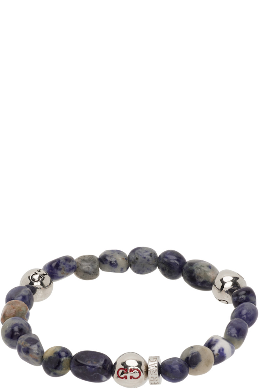 Elasticized beaded stone bracelet in brown and navy.

· Logo-engraved silver-tone brass beads
· D2.75"

Supplier color: Sodalite/Palladium