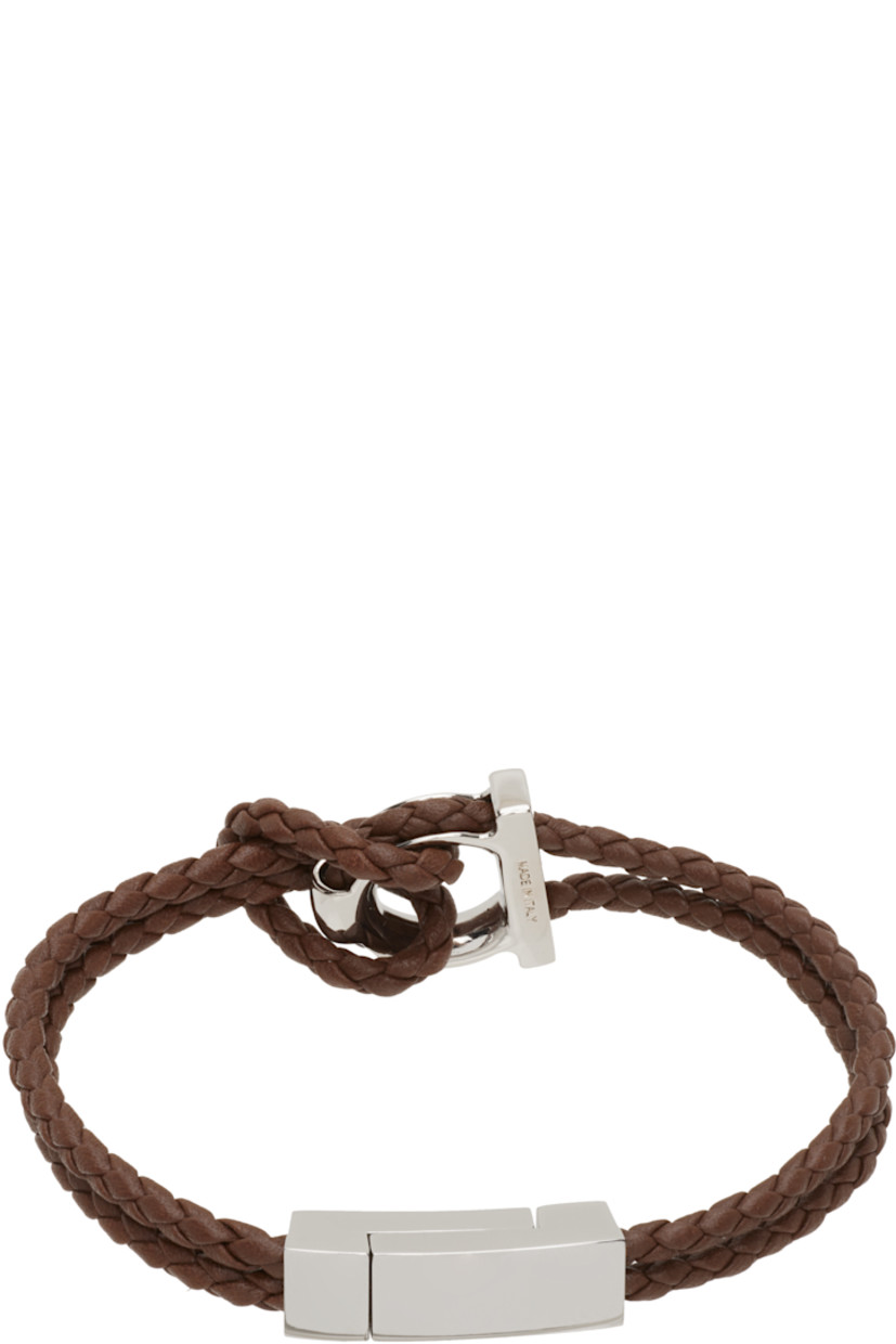 Braided buffed calfskin bracelet in brown.

· Logo hardware at face
· Magnetic fastening 
· Silver-tone brass hardware 
· L7.5"

Supplier color: Brown
