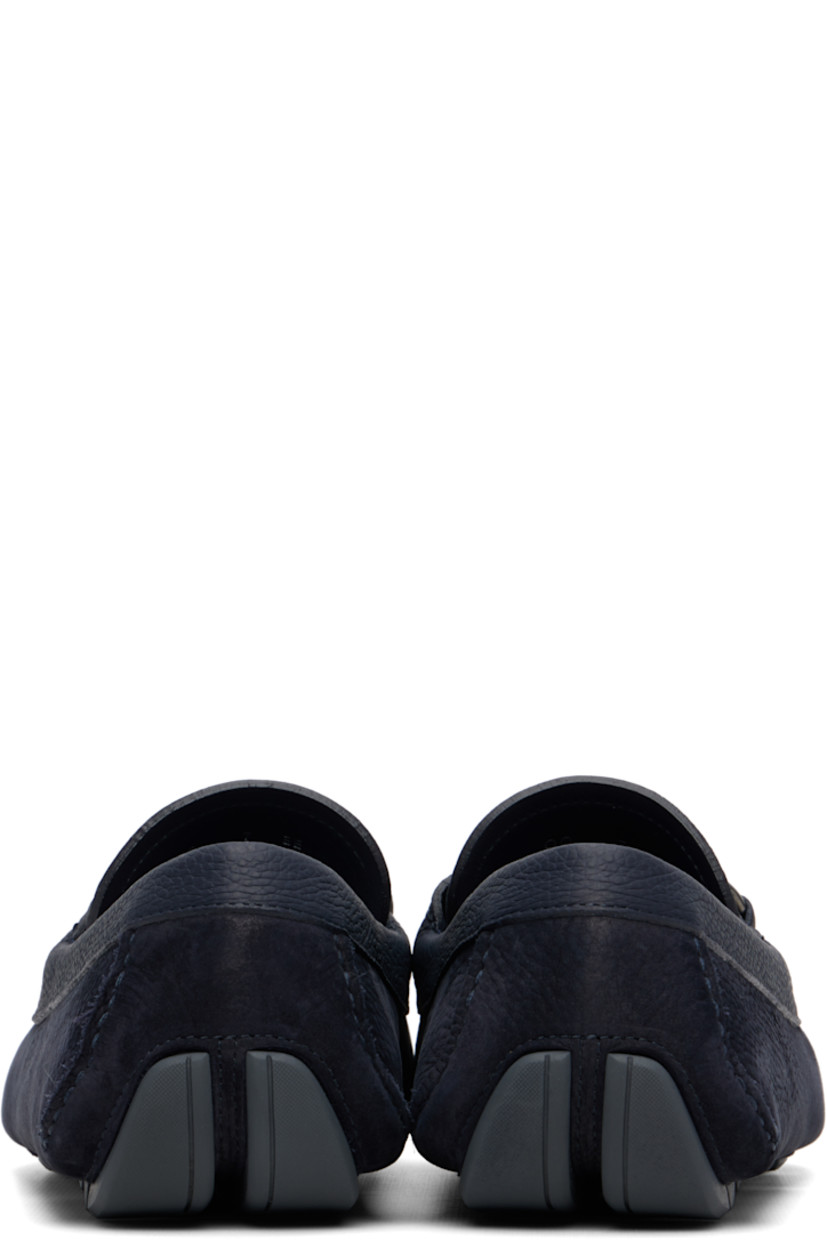 Calfskin nubuck loafers.

· Moc toe
· Strap with logo hardware at vamp
· Buffed leather lining
· Pebbled rubber sole

Supplier color: Navy Blue