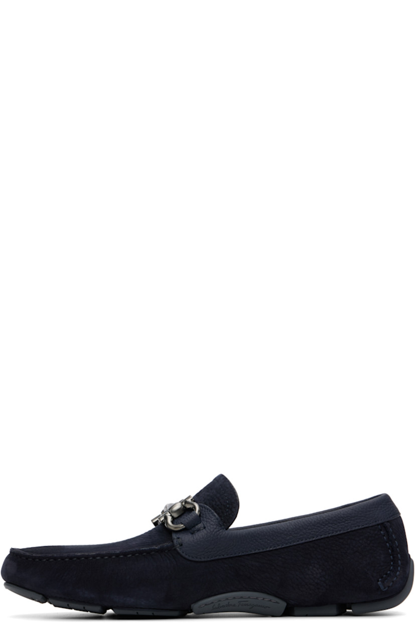 Calfskin nubuck loafers.

· Moc toe
· Strap with logo hardware at vamp
· Buffed leather lining
· Pebbled rubber sole

Supplier color: Navy Blue