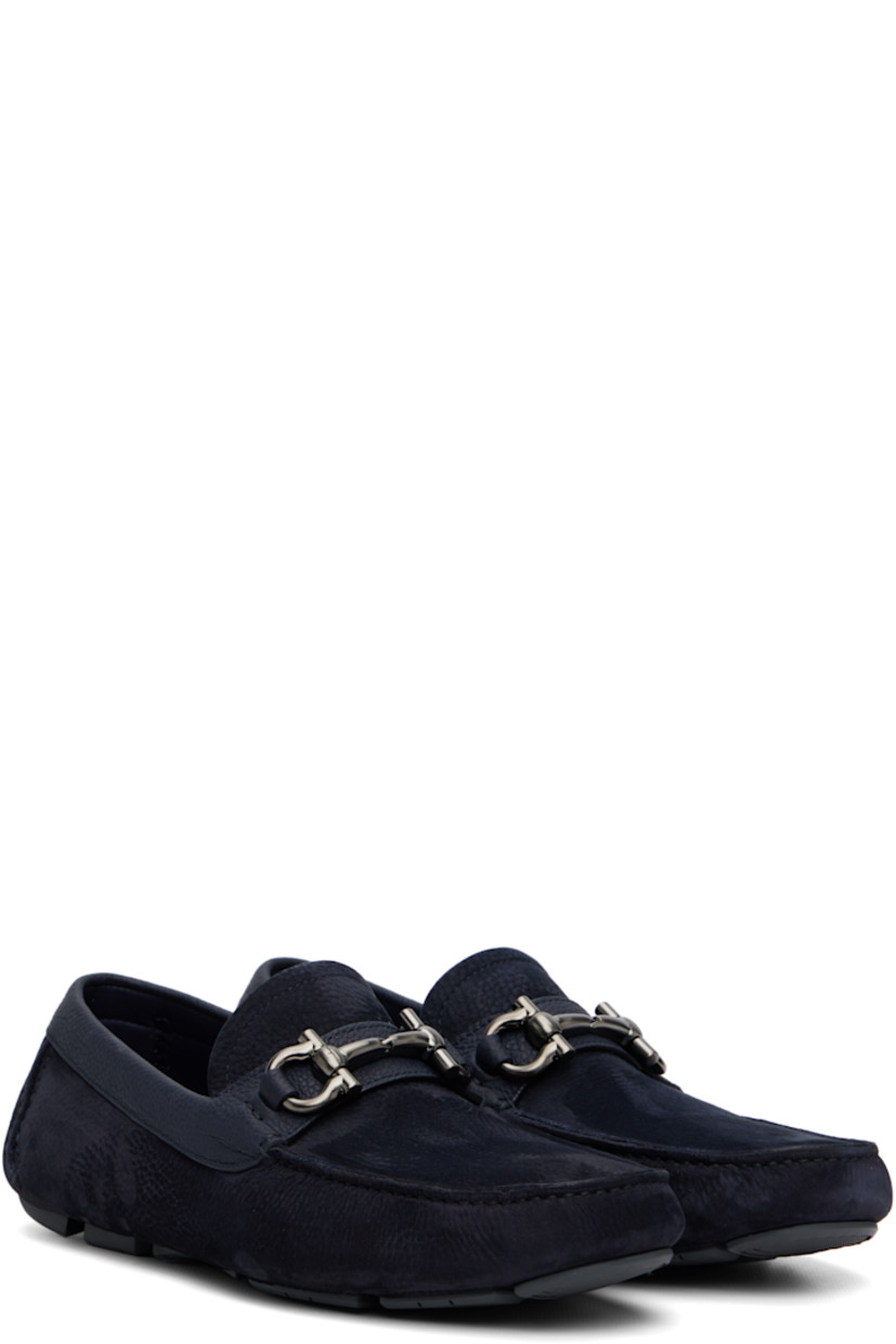 Calfskin nubuck loafers.

· Moc toe
· Strap with logo hardware at vamp
· Buffed leather lining
· Pebbled rubber sole

Supplier color: Navy Blue