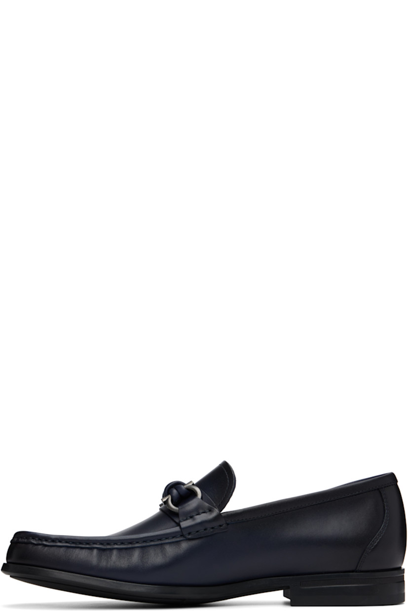 Buffed calfskin loafers.

· Square moc toe
· Logo hardware at vamp
· Calfskin suede lining
· Rubber sole

Supplier color: Navy