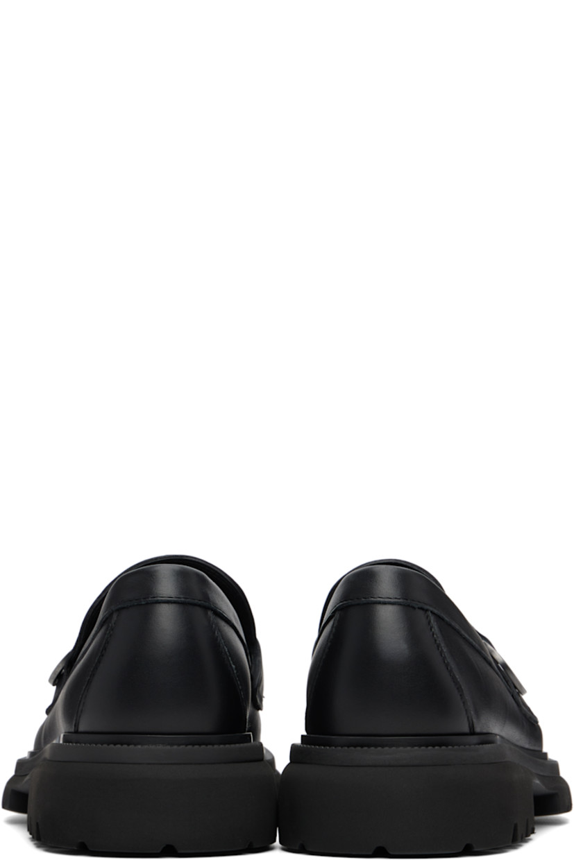 Buffed calfskin loafers.

· Moc toe
· Strap with logo hardware at vamp
· Buffed leather lining
· Treaded rubber sole
· Heel: H1.5"

Supplier color: Black