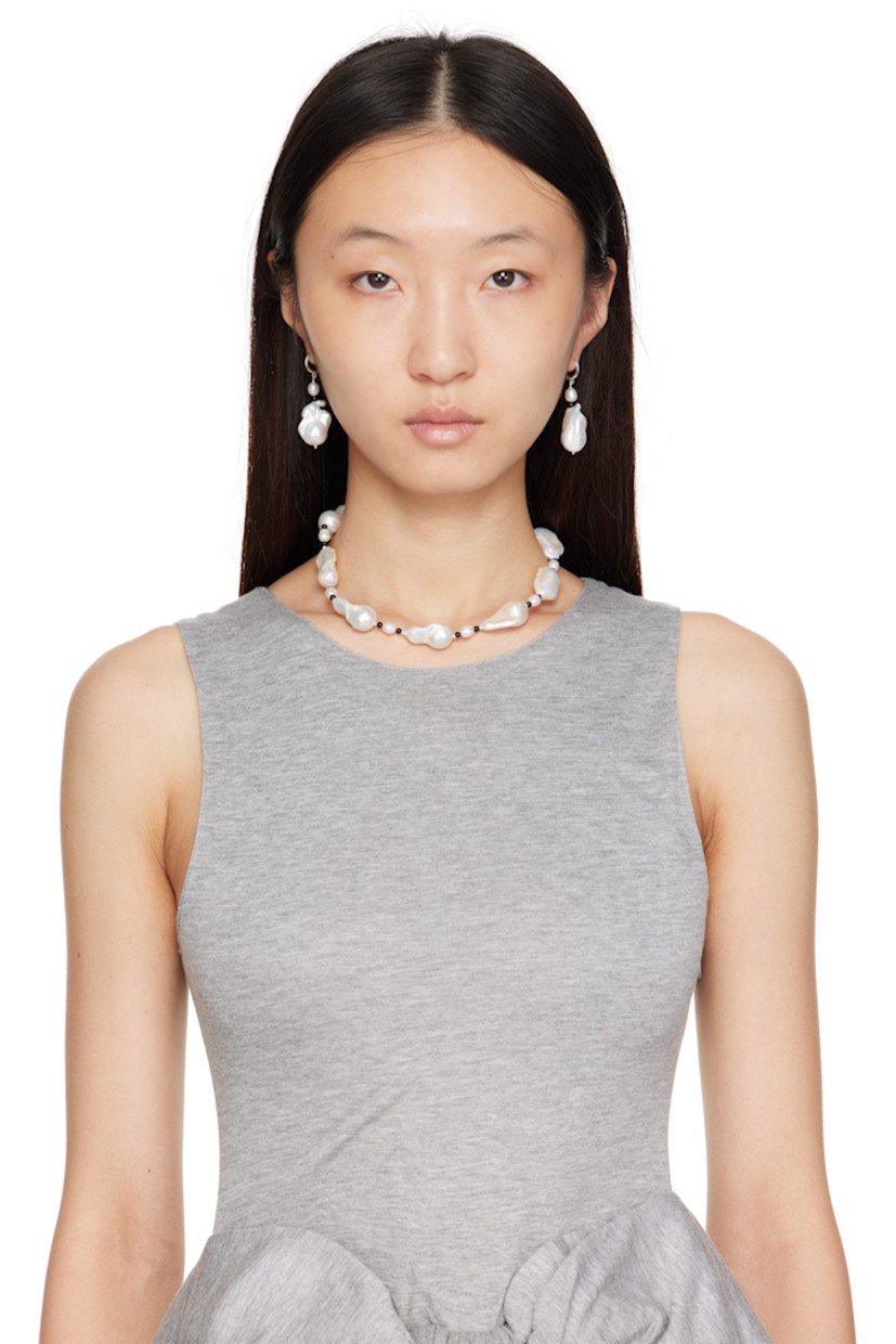 Pair of handcrafted beaded baroque pearl drop earrings.

· Onyx stone at length
· Hinged-post fastening
· Sterling silver hardware
· H2" x W0.75"

Part of the Gohar World Table VII collection.

Supplier color: White/Onyx
