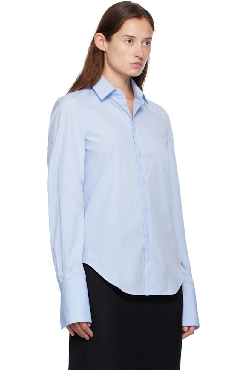 Cotton poplin shirt. 

· Spread collar 
· Button closure 
· Shirttail hem
· Pleats at buttoned barrel cuffs
· Box pleat at back yoke 

Supplier color: Blue