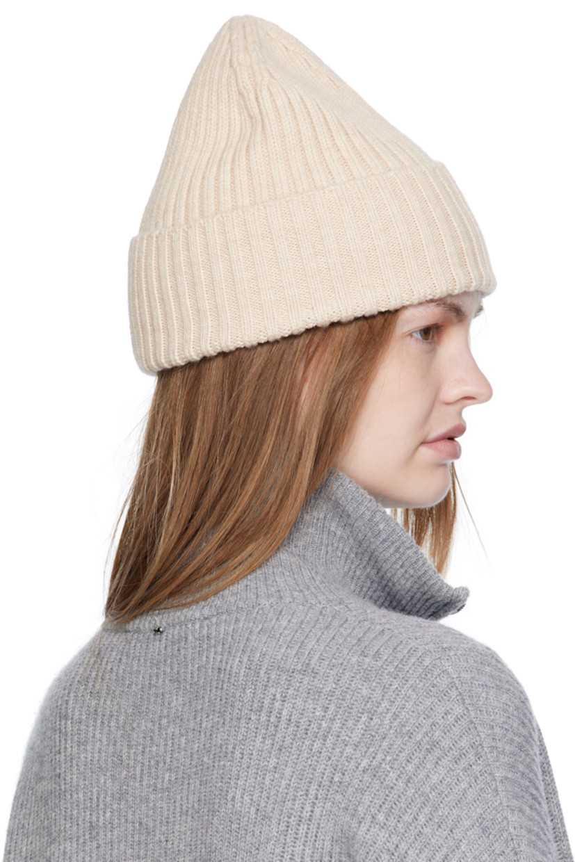 Rib-knit merino wool beanie. Logo embroidered at rolled brim.

Supplier color: Beige