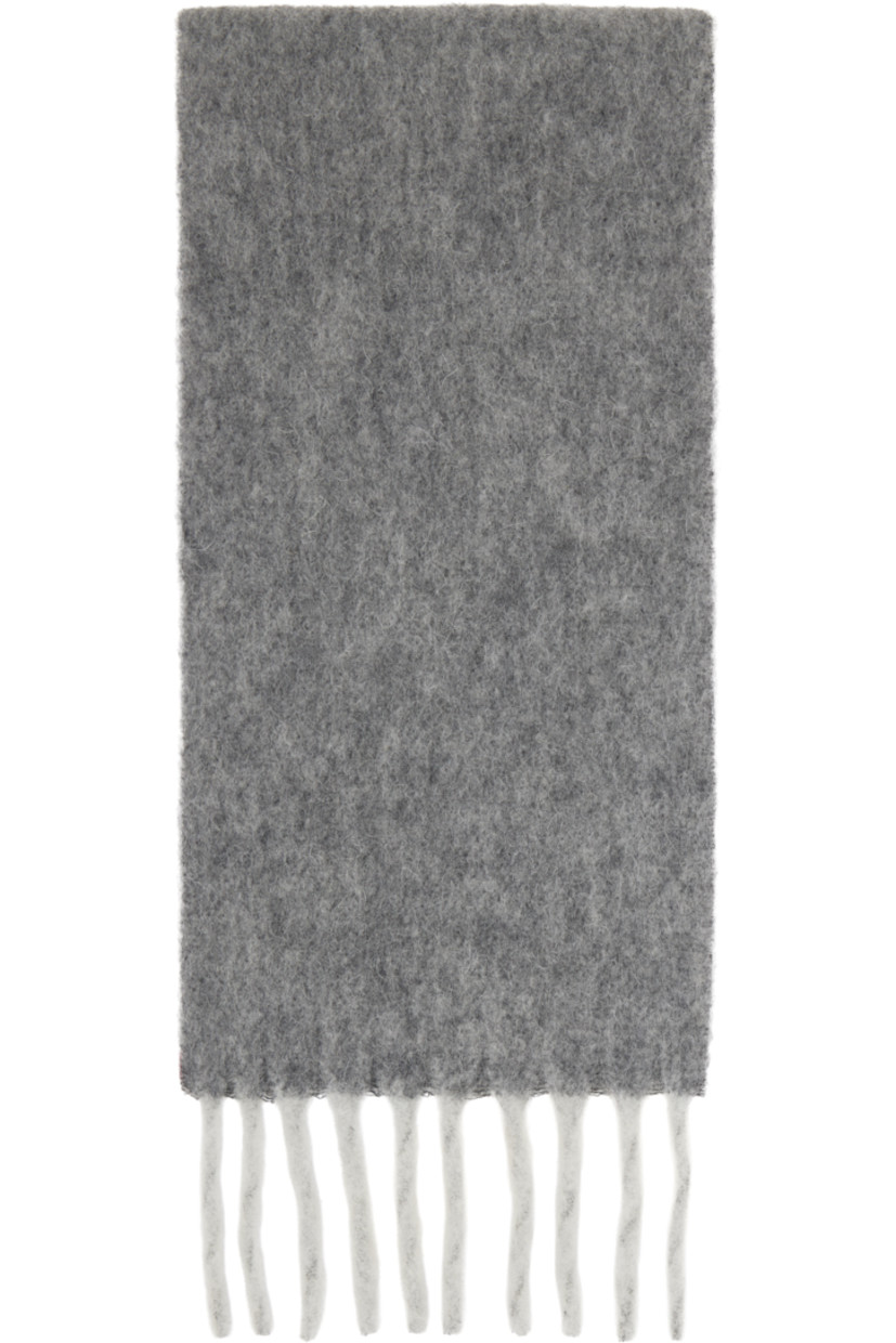 Rectangular brushed knit wool- and alpaca-blend scarf.

· Logo appliqué at face
· Fringed detailing at ends
· L76.75" x W10"

Supplier color: Grey