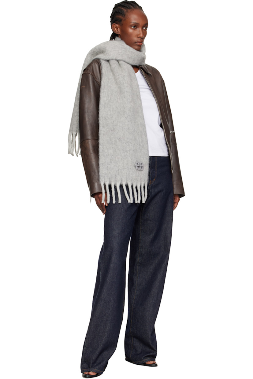 Rectangular brushed knit wool- and alpaca-blend scarf.

· Logo appliqué at face
· Fringed detailing at ends
· L76.75" x W10"

Supplier color: Grey