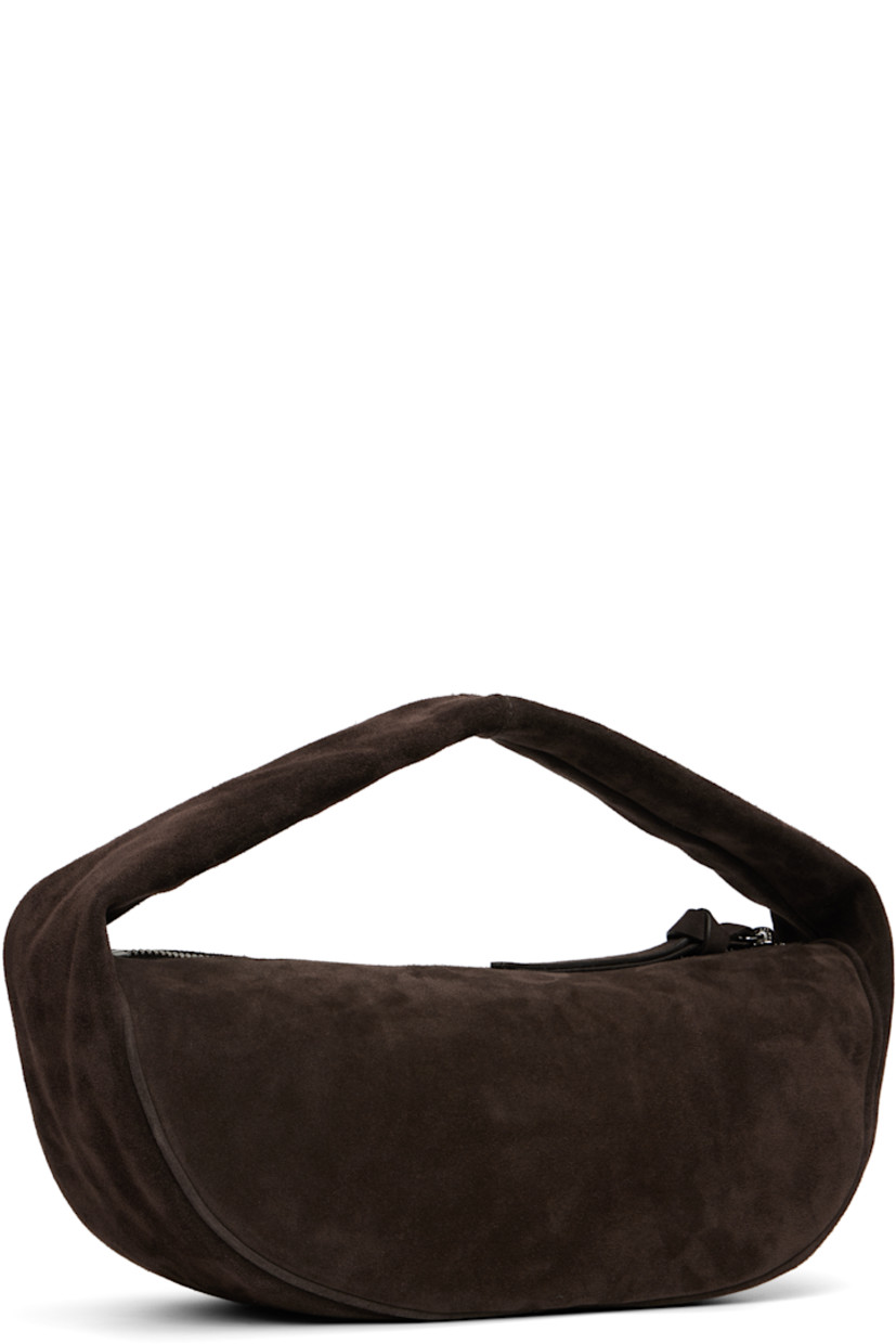 Suede top handle bag.

· Integrated shoulder strap
· Zip closure
· Microfiber lining
· H6" x W12.5" x D5"

Supplier color: Ristretto