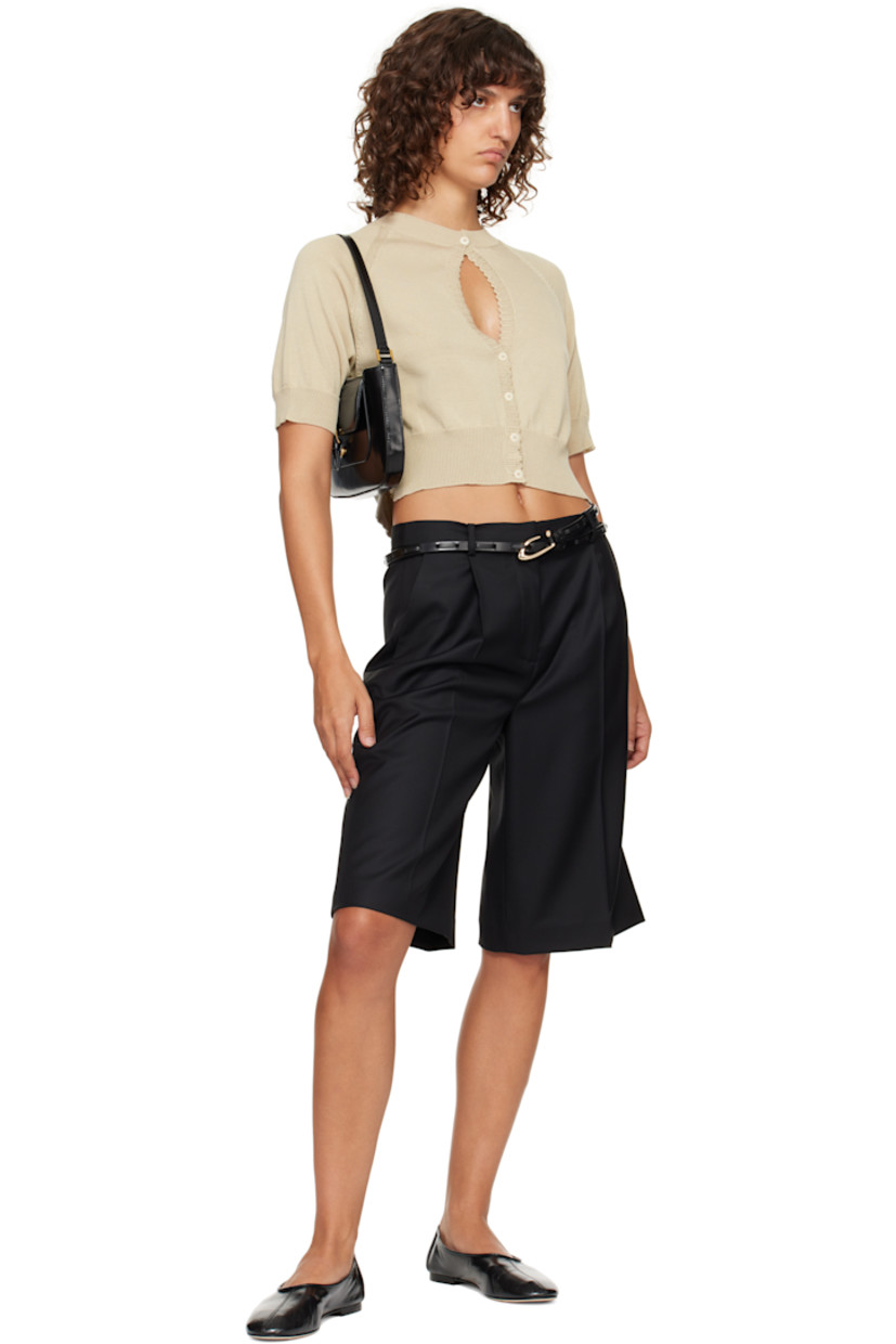 Patent leather shoulder bag.

· LWG-certified leather
· Fixed shoulder strap
· Pin-buckle hardware at magnetic press-stud flap
· Patch pocket at interior
· Cotton twill lining
· H6" x W10.75" x D1"

Supplier color: Black