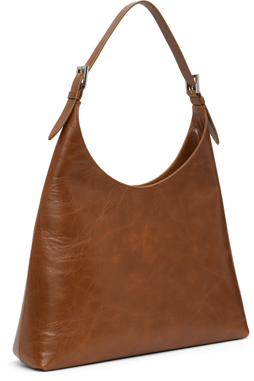Crinkled leather shoulder bag.

· Adjustable and detachable shoulder strap
· Magnetic closure
· Patch pocket at interior
· Microfiber lining
· Logo-engraved silver-tone hardware
· H14" x W15" x D4"

Supplier color: Tan