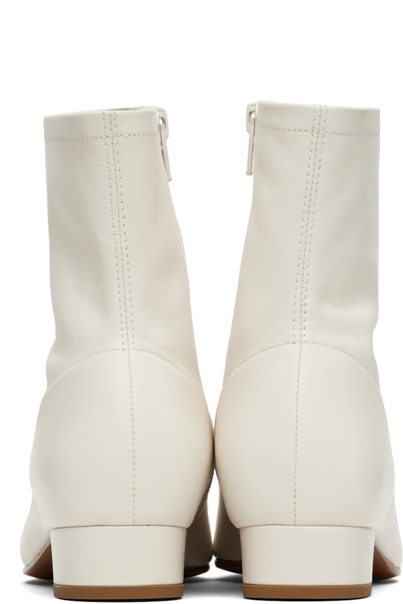 Ankle-high grained lambskin boots.

· LWG-certified lambskin
· Square toe
· Zip closure at inner side
· Covered block heel with rubber injection
· Nubuck sole
· Heel: H1"

Supplier color: White