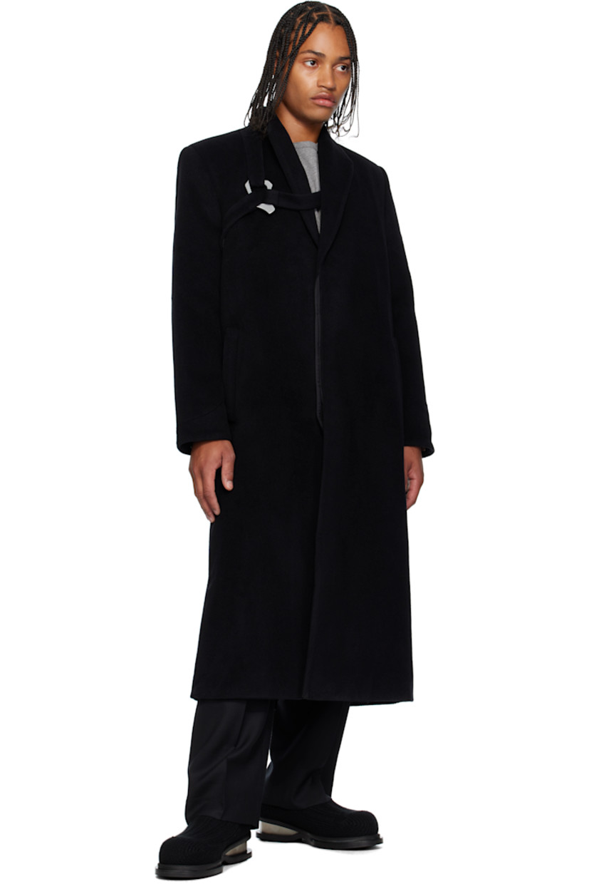 Wool- and cashmere-blend melton coat. 

· Shawl collar 
· Concealed button closure
· Harness-style strap with carabiner at chest 
· Welt pockets at waist 
· Padded shoulders
· Press-stud fastening at cuffs
· Central vent at back hem 
· Welt pocket at interior 
· Full recycled satin lining 

Supplier color: Black