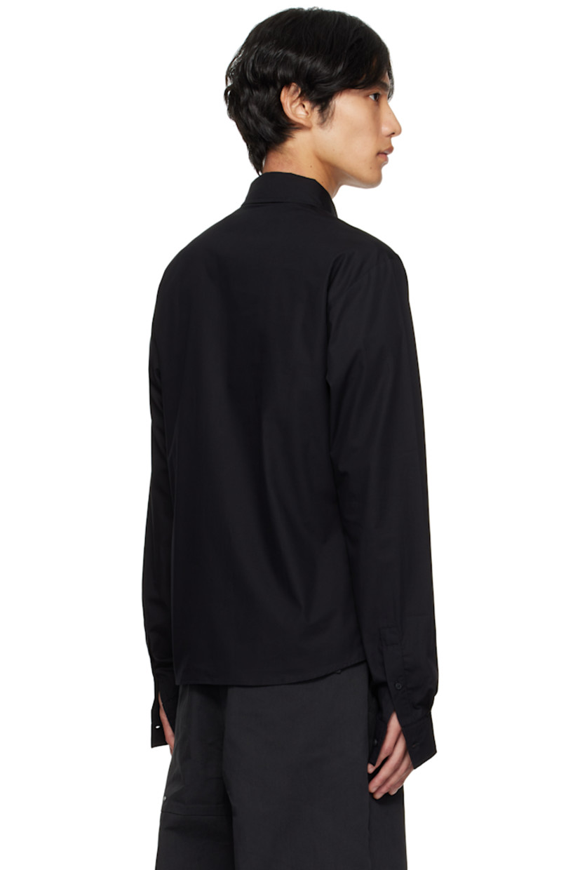 Organic cotton poplin shirt.

· Spread collar
· Self-tie strap with logo-engraved graphic hardware at collar
· Button closure
· Shirttail hem
· Buttoned barrel cuffs

Supplier color: Black