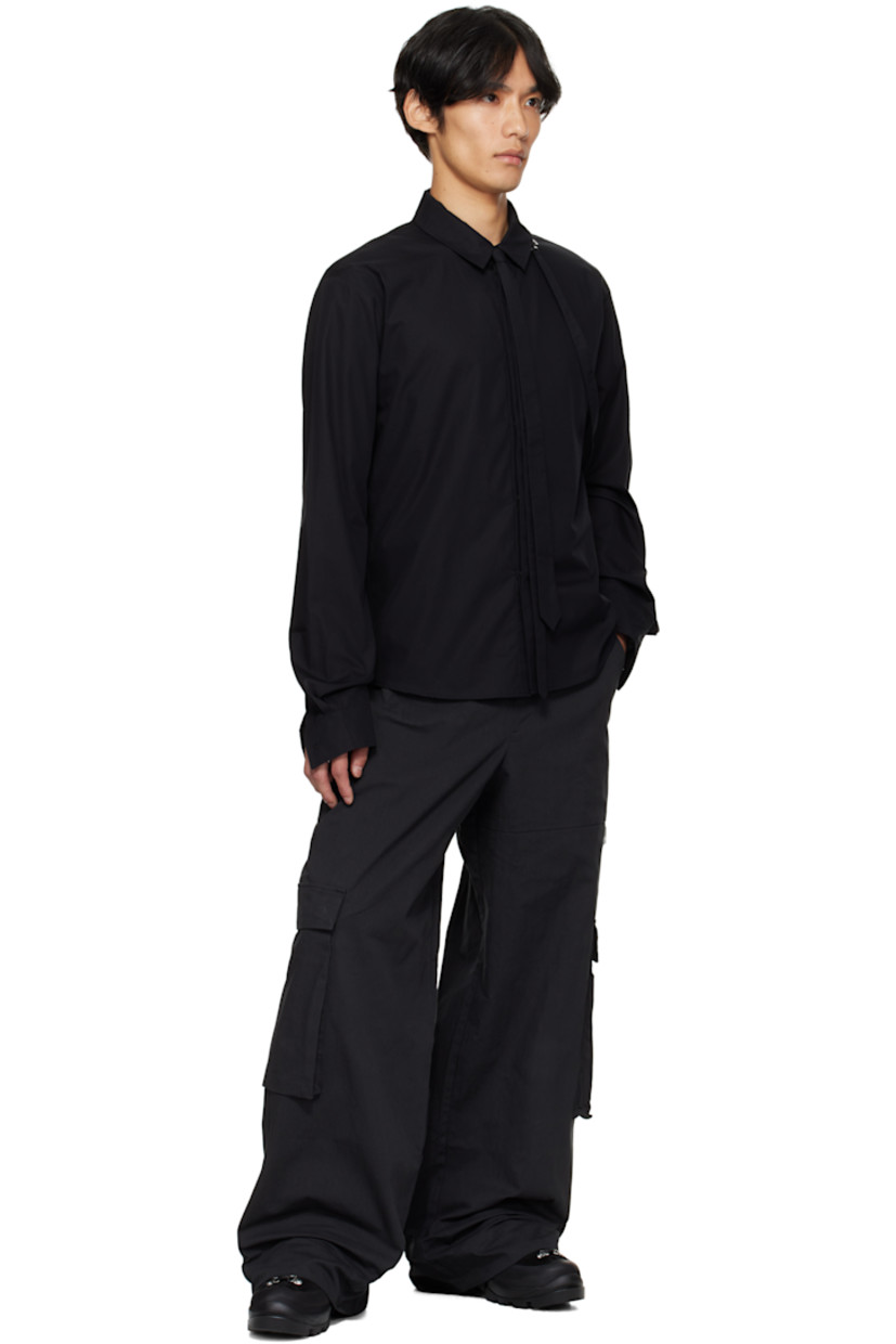 Organic cotton poplin shirt.

· Spread collar
· Self-tie strap with logo-engraved graphic hardware at collar
· Button closure
· Shirttail hem
· Buttoned barrel cuffs

Supplier color: Black