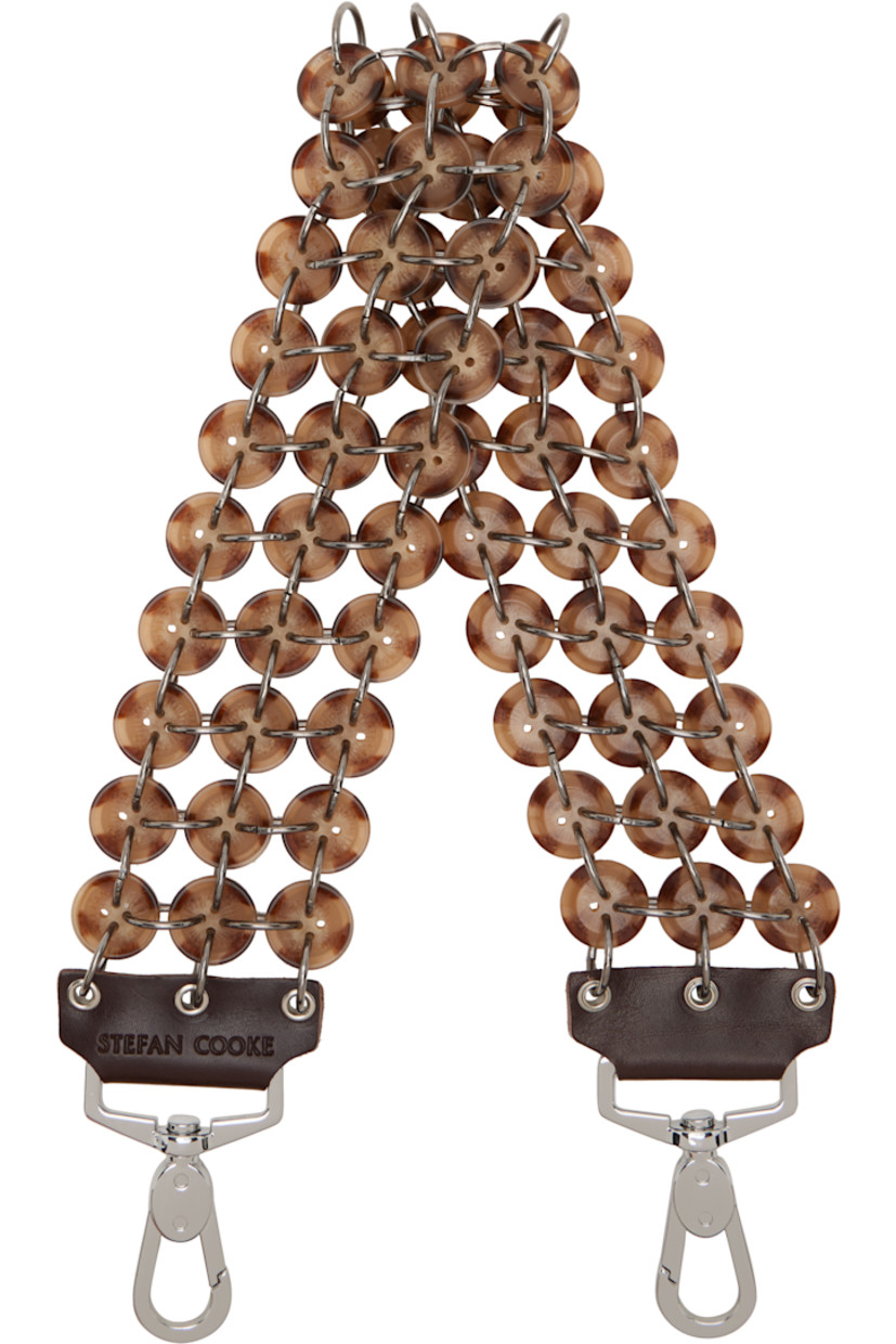 Modified chain link bag strap.

· Metal rings and logo-engraved button links
· Clasp with logo-embossed leather trim at ends
· L25" x W2.5"

Supplier color: Brown