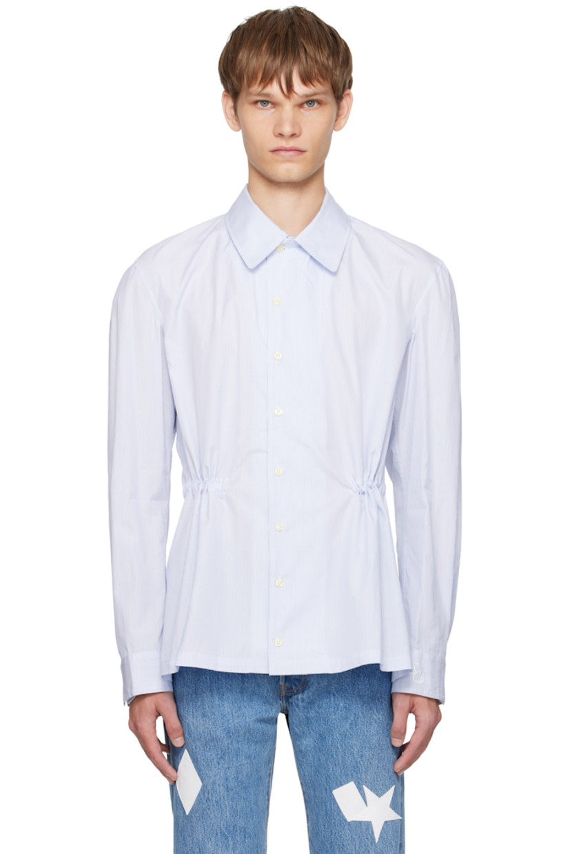 Cotton oxford cloth shirt. 

· Pinstripes throughout 
· Spread collar 
· Button closure
· Buttoned barrel cuffs
· Logo embroidered at cuff
· Self-tie drawstring at interior waist 

Supplier color: Blue pinstripe