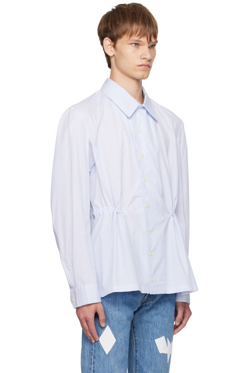 Cotton oxford cloth shirt. 

· Pinstripes throughout 
· Spread collar 
· Button closure
· Buttoned barrel cuffs
· Logo embroidered at cuff
· Self-tie drawstring at interior waist 

Supplier color: Blue pinstripe