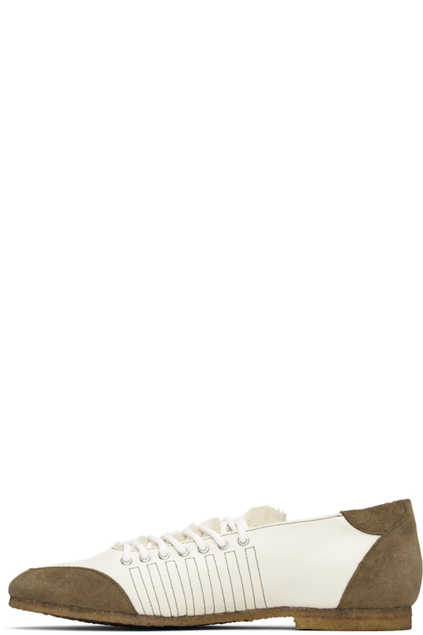 Low-top buffed leather and suede sneakers.

· Lace-up closure
· Logo patch at padded shearling tongue
· Padded collar
· Buffed leather lining
· Crêpe-rubber sole

Supplier color: White/White