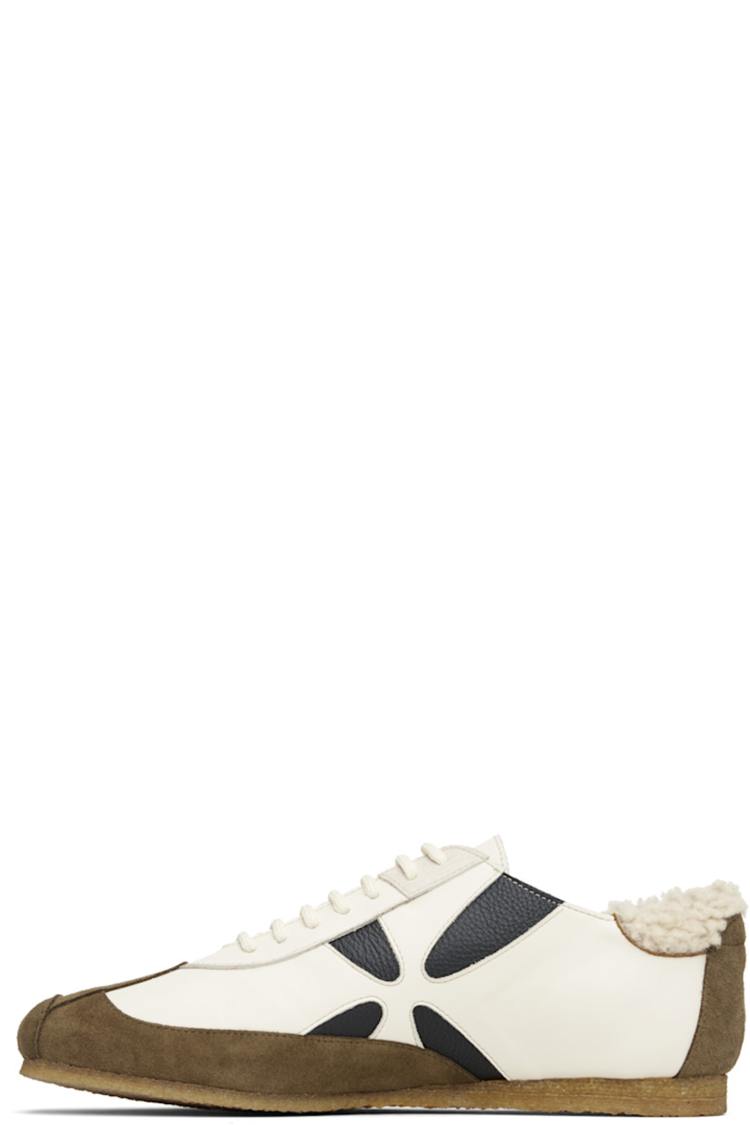 Low-top suede and buffed leather sneakers.

· Square toe
· Lace-up closure
· Shearling trim at padded heel collar
· Graphic cutouts at sides
· Buffed leather lining
· Crêpe-rubber sole

Supplier color: White/White